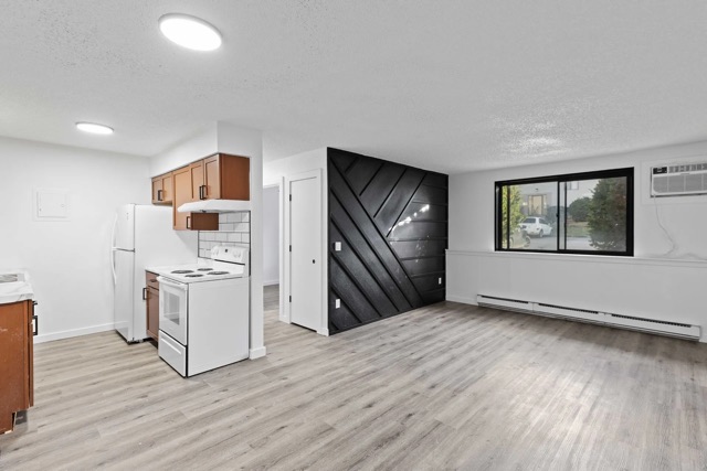 Renovated kitchen with wood cabinets and subway tile at The Cypress